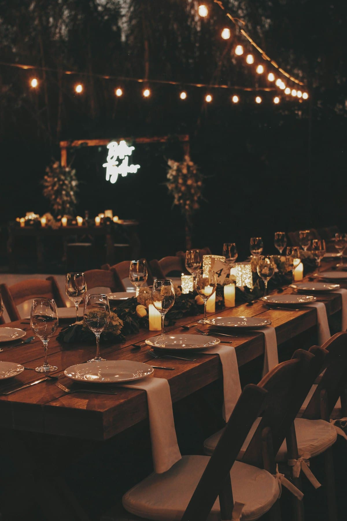 Candlelit wedding table with layered linens and florals