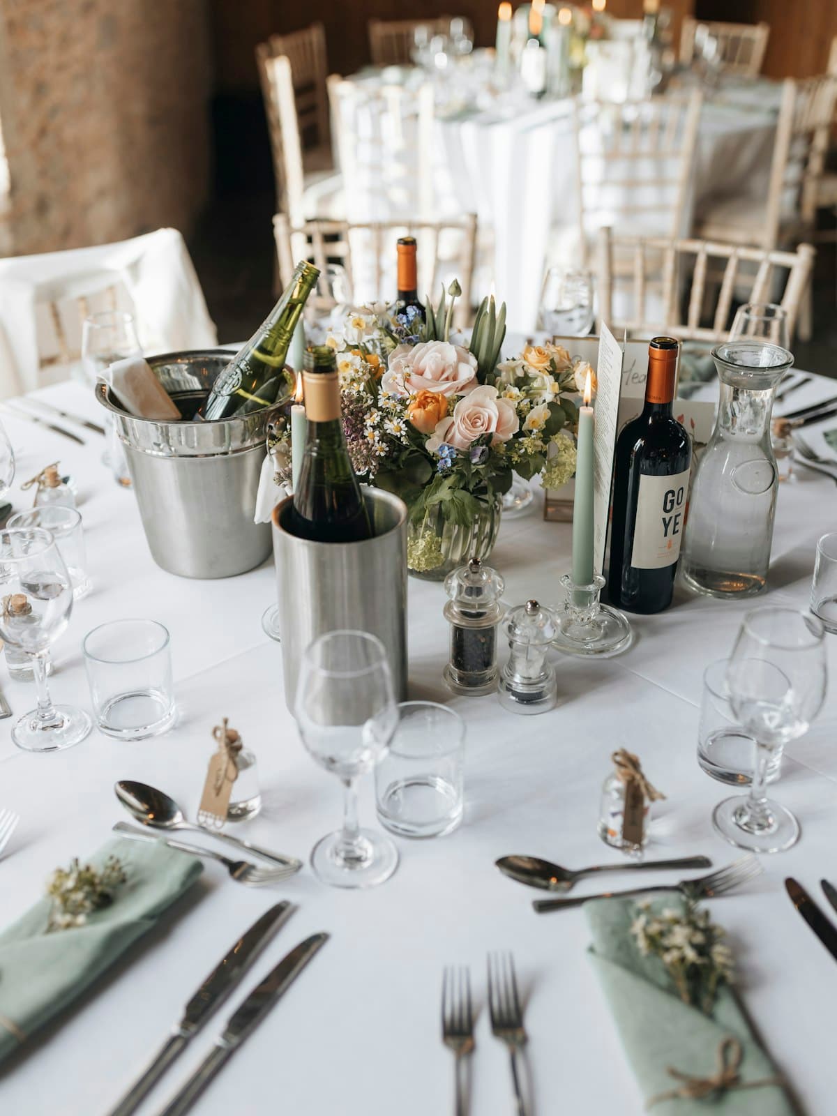 Cream and bone wedding tablescape with matched linens in soft daylight