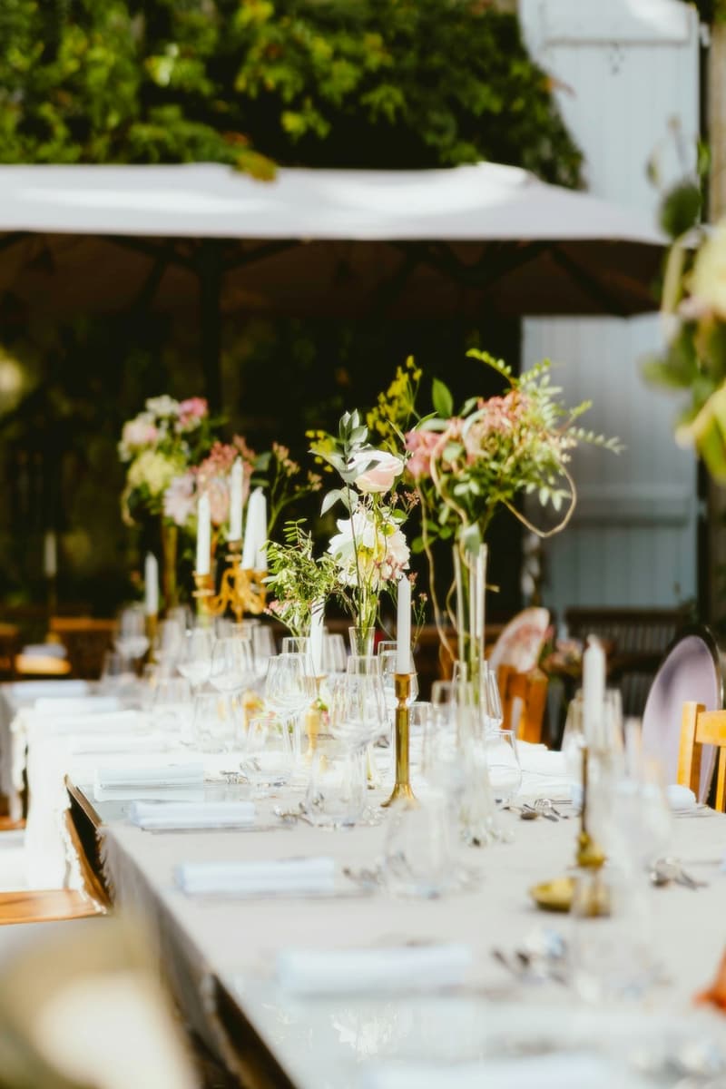 Round reception table dressed with a floor-length tablecloth and napkins