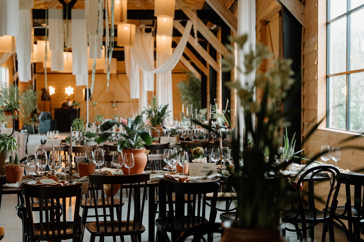 Barn wedding reception with long color-matched tables