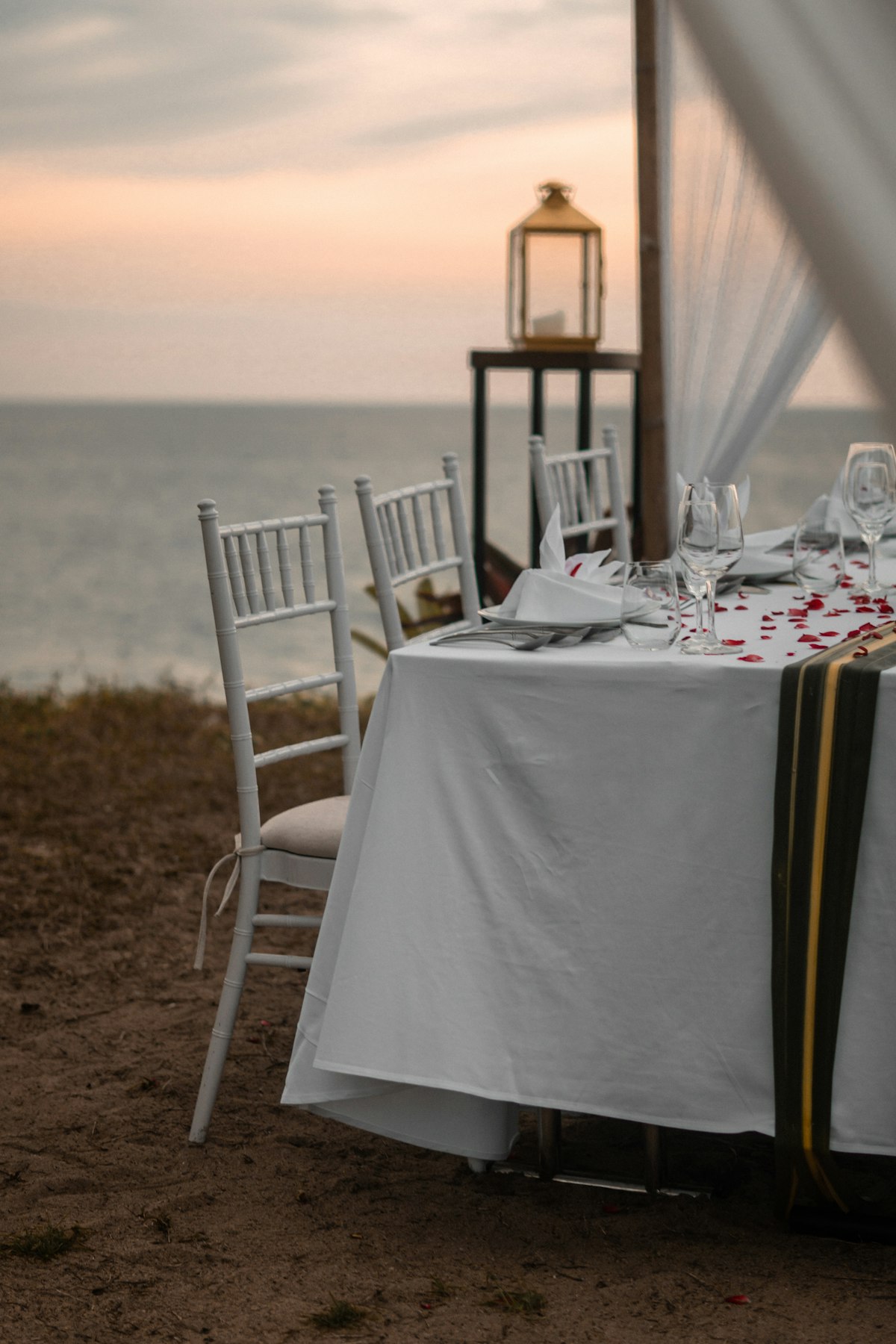 Coastal wedding table set against an open-air view